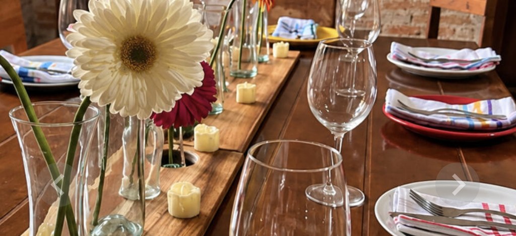 A table set for dinner with flowers, candles, and wine glasses